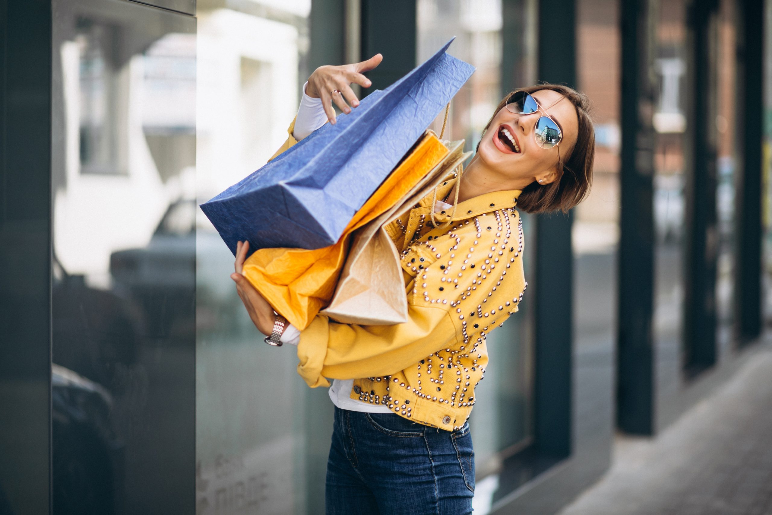 Young woman with shopping bags in the city