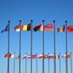 Die Vielfalt bei einer Internationale Kundenbefragung ist durch verschiedene Flaggen zu sehen, die an Masten hängen.